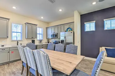 a kitchen with a wooden table and chairs at Home with Hot Tub 4 Mi to Disney! in Orlando