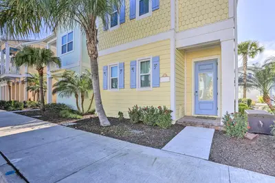 a yellow house with a blue door and palm trees at Home with Hot Tub 4 Mi to Disney! in Orlando