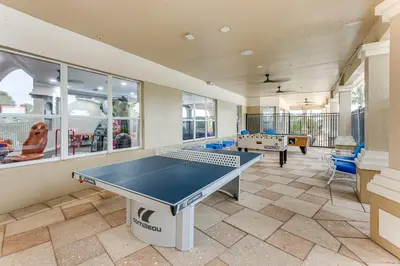 a large room with a ping pong table in it at Private Cocktail Pool Kissimmee Resort Retreat! in Orlando