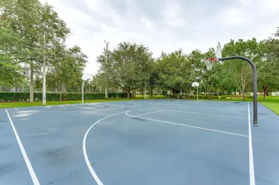 a basketball court in a park with a hoop at Private Cocktail Pool Kissimmee Resort Retreat! in Orlando