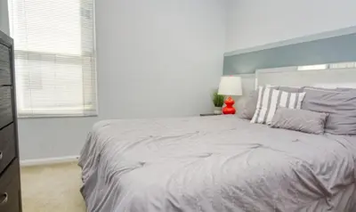 a white bedroom with a large bed in a room at 5 Bedroom 3 and half Bathroom Luxury Villa at Windsor Palms in Kissimmee