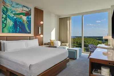 a hotel room with a bed and a large window at Walt Disney World Swan Reserve in Orlando