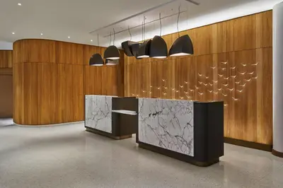 a lobby with wooden walls and a counter with lights at Walt Disney World Swan Reserve in Orlando