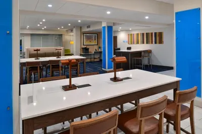 a lobby with a large table and chairs at Holiday Inn Express Orlando - South Park by IHG in Orlando