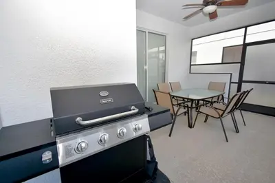a kitchen with a stove and a table with chairs at Luxury Pool Home, Spa, Grill- 1664St in Kissimmee
