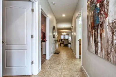 a hallway with a door leading to a living room at Dog Friendly Townhome Wsplashpool- 1600St in Kissimmee