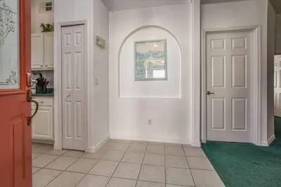 a hallway with two doors and a painting on the wall at Indian Ridge - 4 Bedroom Pool Home- 2408Ir in Orlando