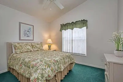 a bedroom with a bed and a window at Indian Ridge - 4 Bedroom Pool Home- 2408Ir in Orlando