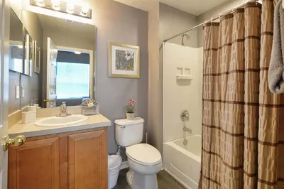a bathroom with a toilet and a sink and a shower at Serene Pool & Spa, Gated Resort- 2201Em in Kissimmee