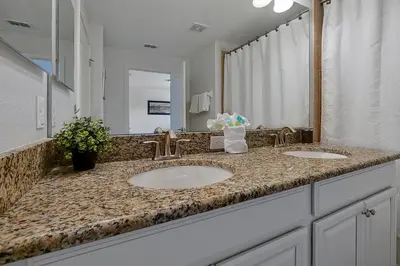 a bathroom with two sinks and a large mirror at Rare Waterfront Wspashpool, Resort -3091Pp in Kissimmee