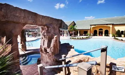a large swimming pool in a resort with a building at Rare Waterfront Wspashpool, Resort -3091Pp in Kissimmee