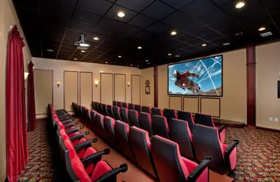 a cinema room with red chairs and a screen at Rare Waterfront Wspashpool, Resort -3091Pp in Kissimmee