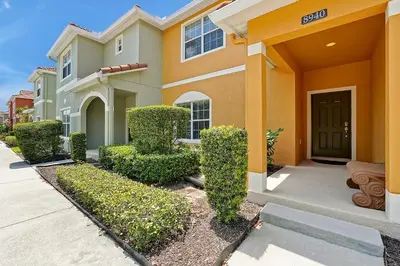 a house with bushes in front of a driveway at Rare Waterfront Wspashpool, Resort -3091Pp in Kissimmee