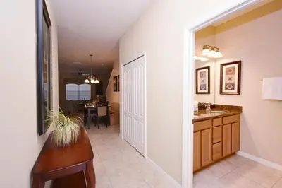 a hallway with a bathroom with a sink and a mirror at Paradise Palms -5 Bed Townhome W-Splashpool-3046Pp in Kissimmee