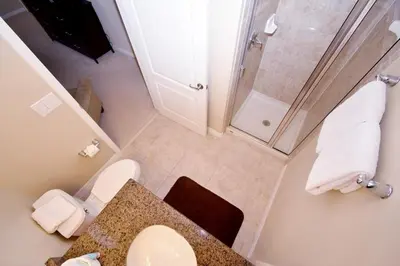 a small bathroom with a toilet and a shower at Paradise Palms -5 Bed Townhome W-Splashpool-3046Pp in Kissimmee