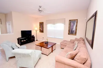 a living room with a couch and a table at Paradise Palms -5 Bed Townhome W-Splashpool-3046Pp in Kissimmee