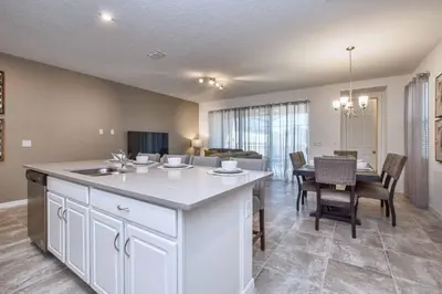 a kitchen and living room with a table and chairs at 5 Bedrooms Townhome W- Splashpool - 8205Sa in Orlando