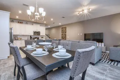 a dining room and kitchen with a table and chairs at 5 Bedrooms Townhome W- Splashpool - 8205Sa in Orlando