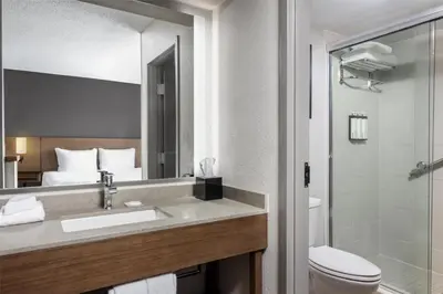 a hotel bathroom with a sink and a toilet at Hyatt Place Orlando Airport in Orlando