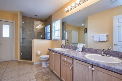 a bathroom with two sinks and a shower at Indian Ridge- 4 Bedroom Pool Home- 2405Ir in Orlando