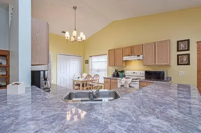 a kitchen with a sink and a counter top at Indian Ridge- 4 Bedroom Pool Home- 2405Ir in Orlando