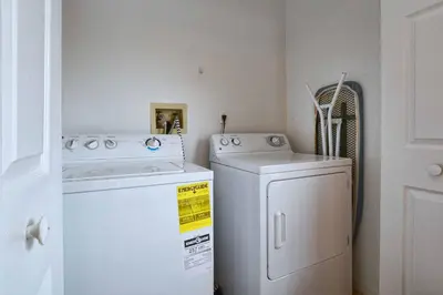 a laundry room with a washer and dryer at Indian Ridge- 4 Bedroom Pool Home- 2405Ir in Orlando