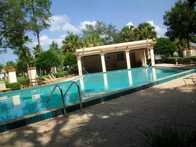 a swimming pool in front of a house at Indian Ridge- 4 Bedroom Pool Home- 2405Ir in Orlando