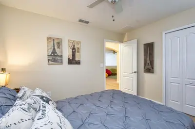 a bedroom with a bed and some pictures on the wall at Pool Home With Privacy, Bbq, Mickey Room - 3500Pp in Kissimmee