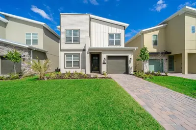 a large house with a brick driveway at 2764SG VILLA 5 BED/5 BA (SANITIZED) in Kissimmee