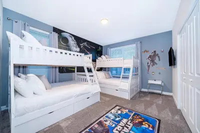 two bunk beds in a room with blue walls at 4352JP VILLA 5 BED/5 BA in Kissimmee