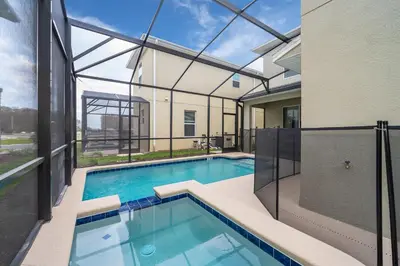 a swimming pool in a house with a glass ceiling at 4352JP VILLA 5 BED/5 BA in Kissimmee