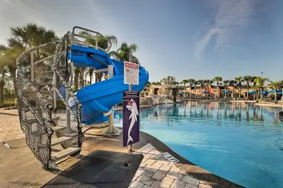 a water slide in front of a swimming pool at Paradise Palms Home with Pool, 6 Mi to Disney! in Kissimmee