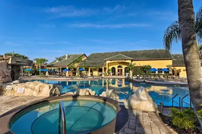 a pool at a resort with a water slide at Paradise Palms Home with Pool, 6 Mi to Disney! in Kissimmee