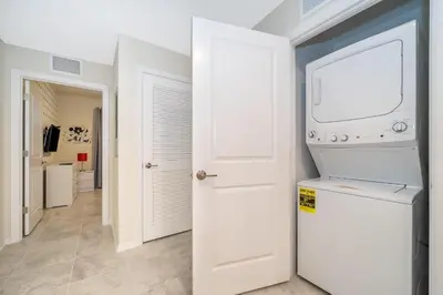 a white laundry room with a washer and dryer at 3150-308BR STOREY LAKE, CONDO 3/2 POOL VIEW in Kissimmee