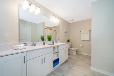 a bathroom with two sinks and a toilet at 3150-308BR STOREY LAKE, CONDO 3/2 POOL VIEW in Kissimmee