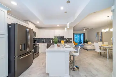 a kitchen with a refrigerator and a dining room at 3150-308BR STOREY LAKE, CONDO 3/2 POOL VIEW in Kissimmee