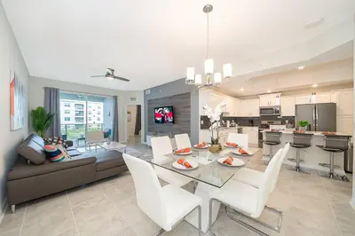 a dining room and living room with a table and chairs at 3180-201JB STOREY LAKE, CONDO 3/2 GARDEN VIEW in Kissimmee