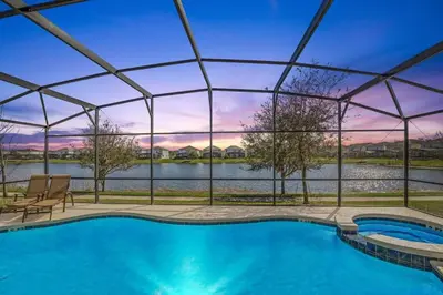 a swimming pool with a view of the water at Stunning LAKE VIEW, Big Pool Area with CDC Standards #6BV507 in Kissimmee