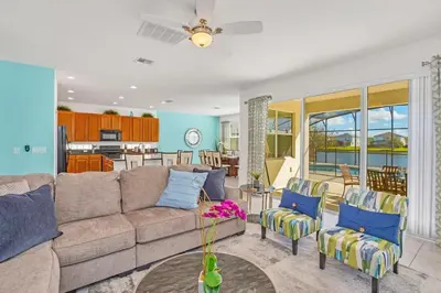 a living room with a couch and chairs at Stunning LAKE VIEW, Big Pool Area with CDC Standards #6BV507 in Kissimmee