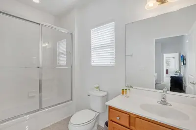 a bathroom with a toilet and a shower and a sink at Stunning LAKE VIEW, Big Pool Area with CDC Standards #6BV507 in Kissimmee