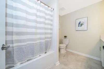 a bathroom with a toilet and a shower curtain at 3180-103EF STOREY LAKE, CONDO 2/2 GARDEN VIEW in Kissimmee