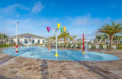 a playground with water fountains in front of a building at 3180-305MN STOREY LAKE, CONDO 2/2 POOL VIEW in Kissimmee