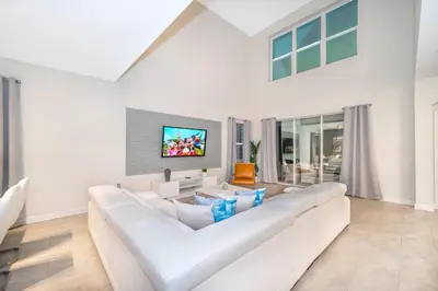 a white living room with a large white couch at 2825PA VILLA 5 BED/5 BA (SANITIZED) in Kissimmee