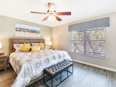 a bedroom with a bed and a ceiling fan at Ohana House at Windsor Hills, Disney World Luxury Rental in Orlando