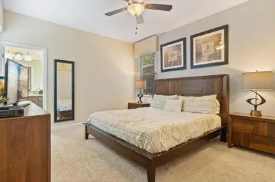a bedroom with a bed and a ceiling fan at Spacious Vacation Home with Pool & Jacuzzi Near Disney in Kissimmee