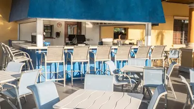 a row of chairs and tables in a cafeteria at Spacious Vacation Home with Pool & Jacuzzi Near Disney in Kissimmee