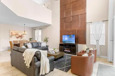 a living room with a couch and a tv at Spacious Vacation Home with Pool & Jacuzzi Near Disney in Kissimmee