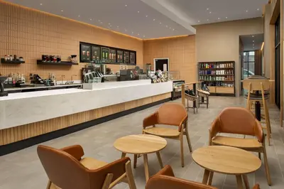 a restaurant with tables and chairs and a counter at Home2 Suites by Hilton Orlando Downtown, FL in Orlando