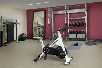 a fitness room with a exercise bike and weights at Home2 Suites by Hilton Orlando Downtown, FL in Orlando