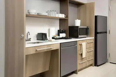 a kitchen with a sink and a refrigerator at Home2 Suites by Hilton Orlando Downtown, FL in Orlando